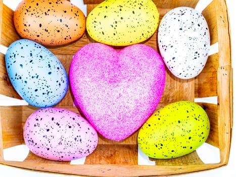 Easter eggs and heart symbol on a white background. Place for text. Template. Background image. Religious holiday. The culture.