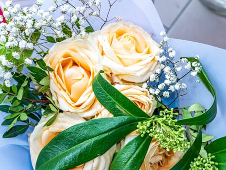 A festive bouquet of cream rose garden flowers. Mothers Day. Birthday. Bridal bouquet. Day of Remembrance. International Women's Day. Place for text. Background image. Advertising. Holiday gift.