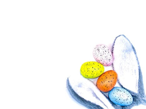 Colored easter eggs and bunny ears on a white background. Holiday. Religion. The culture. Place for text. Background image. Template.