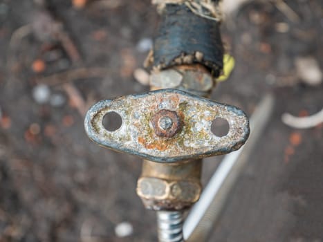 Old plumbing water tap with a metal valve. Equipment. Plumbing work. Water pipe repair. Plumber. Place for text. Background image.
