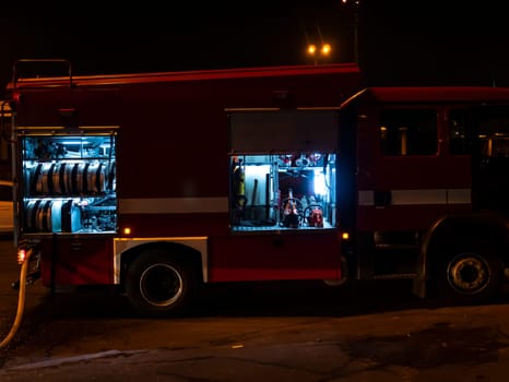 Fire engine during a fire extinguishing at night. Emergency. Help. Background image.