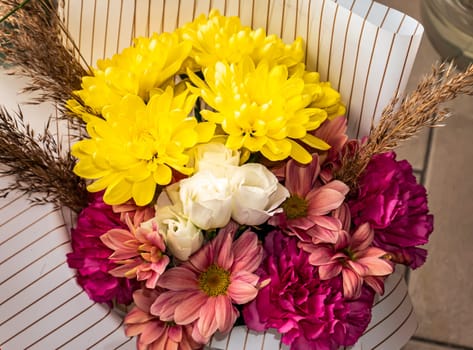 Festive bouquet of red and yellow flowers. Aster. Chamomile. Tulips Birthday. Bridal bouquet. Mothers Day. Valentine's Day. Place for text. Showcase flower shop.