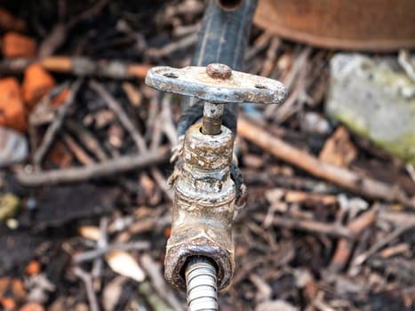 Old plumbing water tap with a metal valve. Equipment. Plumbing work. Water pipe repair. Plumber. Place for text. Background image.