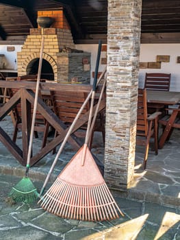 Garden tools fan and rake for cleaning leaves. Garden tools. Place for text. Background image. Cleaning the area.