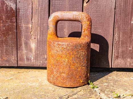 Old rusty iron weight for large weights. Place for text. Background image. Tool.
