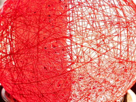 Red thread texture in sunlight from the window. Abstraction. Place for text. Background image.
