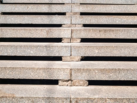 Granite steps for walking from bottom to top. Building sector. Industry. Construction and repair. Place for text. Template. Background image. Poster. Way. Career.