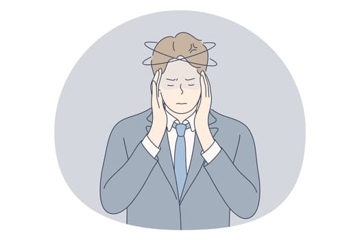 Stress, overwork, overload concept. Unhappy depressed stressed young businessman office worker touching head with fingers, feeling headache, stressed and tired in office. Exhaustion, depression
