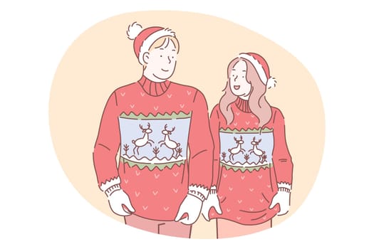 Christmas present, gift, celebration of New Year and winter holidays concept. Smiling young couple in same red sweaters in Santa hats looking at each other during New Year celebration together