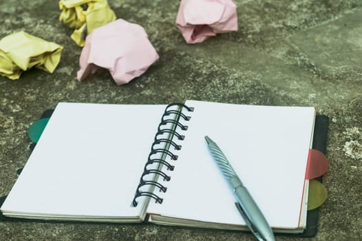 Notebook pen and crumpled paper on rustic floor. Mistake Learning, wrong, blooper, error, regret sayings background. Feelings, apology, message, love, in relationship friendship concept. Flat Lay