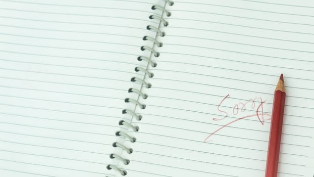 Sorry written on open notebook. Closeup. Mistake learning, blooper, regret sayings in love relationship friendship background. Feelings, apology, reconciliation, misunderstanding concept.