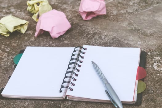 Notebook pen and crumpled paper on rustic floor. Mistake Learning, wrong, blooper, error, regret sayings background. Feelings, apology, message, love, in relationship friendship concept. Flat Lay
