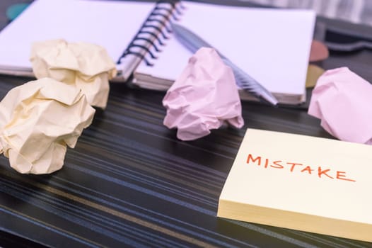 Mistake written on sticky notes. Learning, wrong, blooper, error message, regret sayings background. Fault, defect, careless, lesson correction and reconciliation concept for business finance industry