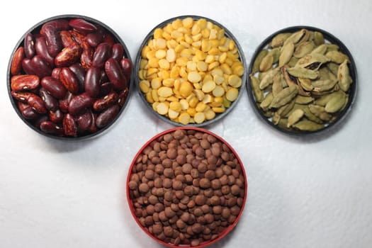Top view of assortment of cereals, and cardamom. Collection of different spices and cereals.