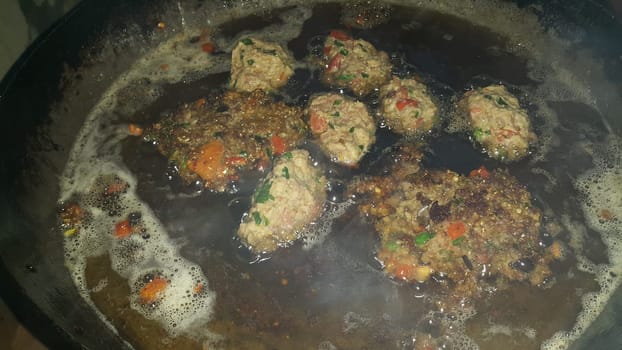 Closeup view with selective focus on delicious spicy fried round kebab served in a ceramic plate