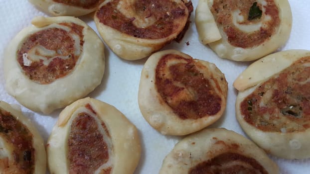 Closeup of delicious home made pinwheel puff pastries food item placed over white background