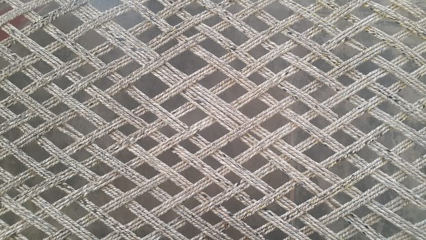 Closeup view of dried jute thread or ropes interwoven for making traditional old style bed called charpai