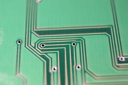 Electronic board with circuit lines and chip. Macro view of green board