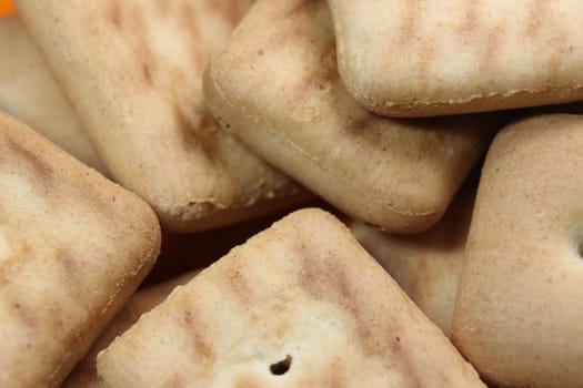 Close up top view of of biscuit cookies. Close up view rectangular biscuits with small pores