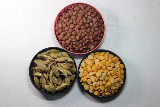 Top view of assortment of cereals, and cardamom. Collection of different spices and cereals.