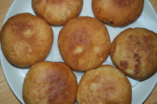 Closeup view of homemade tasty potato bread rolls bun placed over white tissue paper.