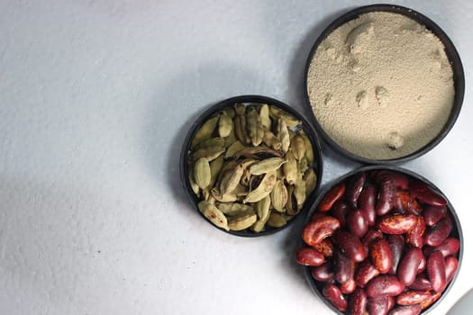 Top view of assortment of cereals, and cardamom. Collection of different spices and cereals.