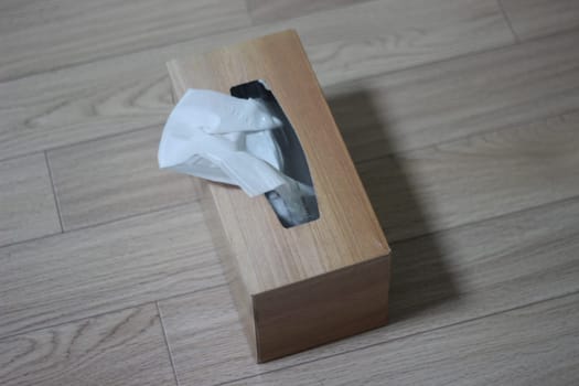 Tissue box of white facial tissue paper on wooden table