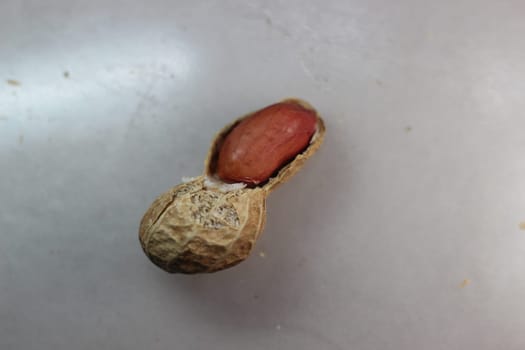 Unpeeled peanut with shells. Food background of peanuts