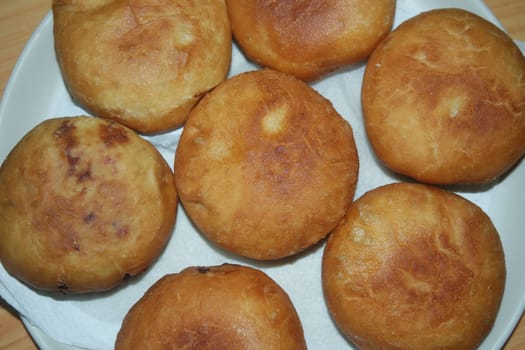 Closeup view of homemade tasty potato bread rolls bun placed over white tissue paper.