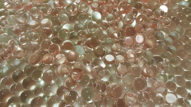 Closeup view with selective focus of shiny glittering orbeez or colorful water balls hydrogel. Water beads orbeez background.