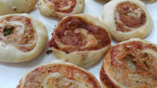 Closeup of delicious home made pinwheel puff pastries food item placed over white background