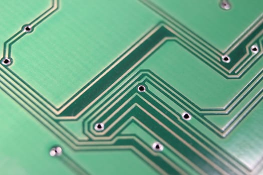 Electronic board with circuit lines and chip. Macro view of green board