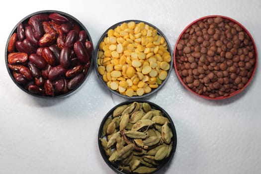 Top view of assortment of cereals, and cardamom. Collection of different spices and cereals.