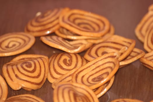 Closeup view with selective focus of a large number of round cookies with coconut filling lines.