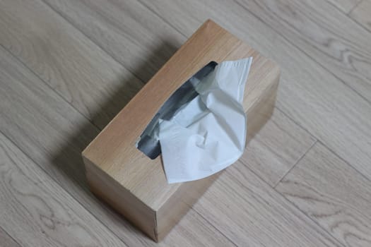 Tissue box of white facial tissue paper on wooden table