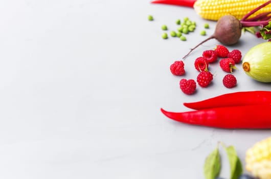 Flat lay with different vegetables, fruits, berries, nuts, spices, herbs, olive oil. Copy space area for some text. Veggies on grey concrete background. Concept of organic bio food healthy eating