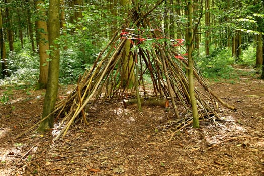 wooden tipi in a forest, children playground