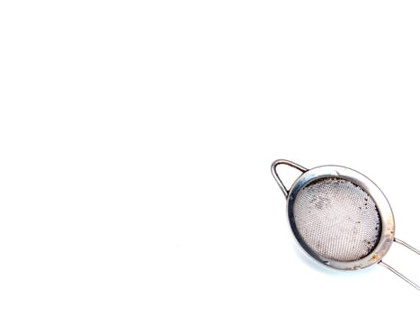 Metal strainer for coffee and tea on a white background. Making tea and coffee. Hot drinks. Kitchen tool. Filter. Home kitchen. Background image. Place for your text. Template.