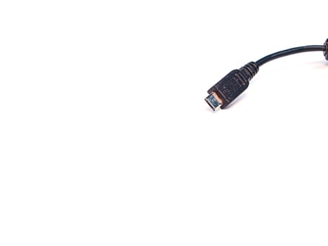 Black usb cord for transferring digital data on a white background. Digital data transmission technologies. Computer connection. Charging mobile devices. USB cord for charging the phone.