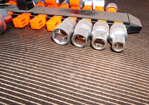 Spanner socket set for nuts and bolts. Locksmith tools for loosening bolts and nuts. Removable wrench caps. Car mechanic metal tool. Repair mechanic's tool. Repair service for equipment. Adding text.