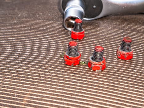 Bolts and nuts loosened with a socket wrench. Locksmith tools for loosening bolts and nuts. Removable wrench caps. Car mechanic metal tool. Repair mechanic's tool. Repair service for equipment.