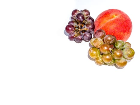 Fruit peach and grapes on a white background. Harvesting. Red peach. Bunch of grapes. Fruit juice. Food photo. Agriculture. Winemaking. Showcase of a fruit shop. Place for text. Poster.