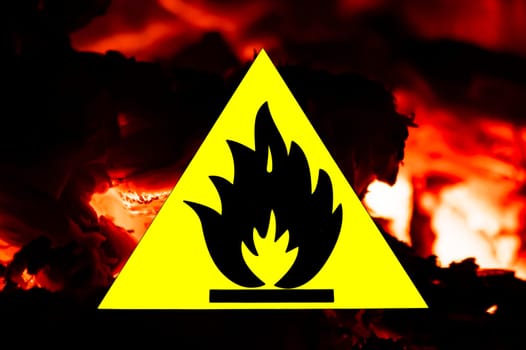 Fire warning sign on the background of fire. Fire on a yellow background. Risk of fire. Environment. Background image. Fire rescue service. Place for text. Poster.