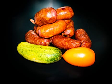 Smoked meat sausages with cucumber and tomato. Food photo. Recipe. Smoked meat. Fatty food. Ofosch. Home kitchen. Menu of dishes. Advertising photo of the store. Place for text. Poster.