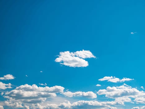 Blue sky with white clouds in sunlight. Cloudy landscape. Nature. Space. Background image. Place for text. Template. Poster. Look into the distance. Admire the view. Summer season. Cloudy horizon.