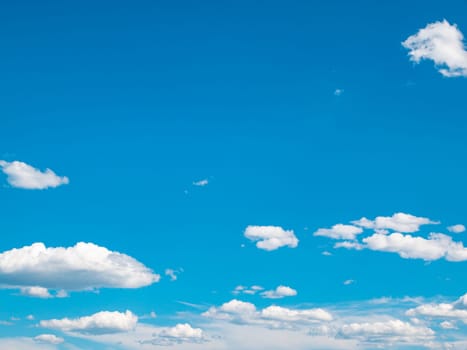 Blue sky with white clouds in sunlight. Cloudy landscape. Nature. Space. Background image. Place for text. Template. Poster. Look into the distance. Admire the view. Summer season. Cloudy horizon.