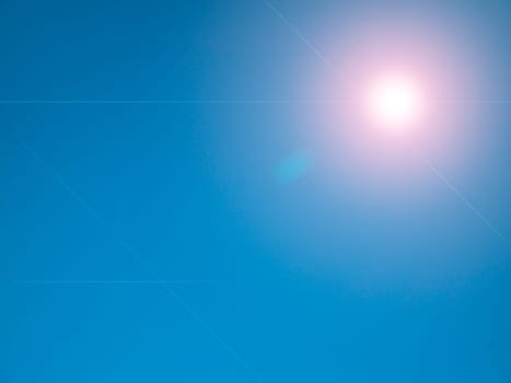 Sun rays on a background of blue sky. Natural background. Lens flare in the sun. Heavenly landscape. Space. Stratosphere. Background image. Poster. Place for text. Clear sky.