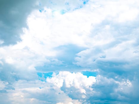 The sun on the background of the cloudy sky. Background image. Sun glare. Camera lens flare. Place for text. Poster. Template. Cloudy landscape. Weather cyclone. Windy weather. Climate change.