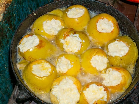 Baked apples stuffed with cottage cheese in a pan. Food photo. Sweet food menu. Dessert. Cooking food. Home kitchen. Showcase advertising photo. Place for text. Background image.