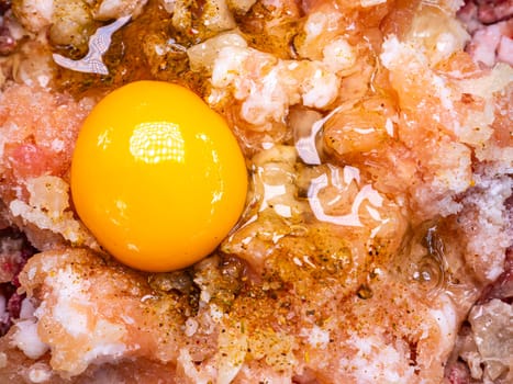The yolk of a raw chicken egg on minced meat for cooking. Food photo. Meat dish. Preparing food. Cutting meat. Butcher's job. Home kitchen. Recipe. Raw meat. Chicken's meat. Cutlets. Cook.